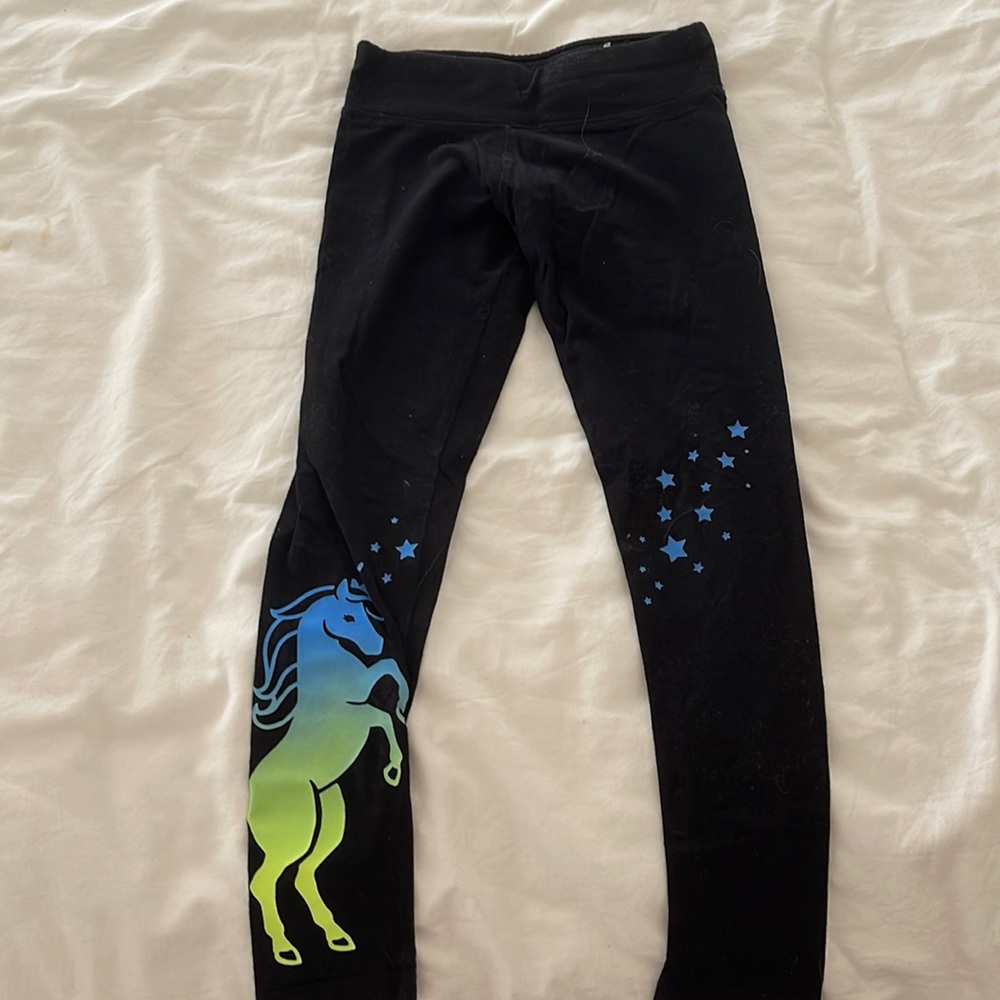 girls black leggings with blue/green unicorn design at the bottom